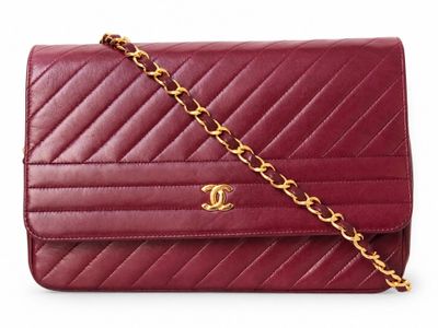 a close up of a red purse on a white background