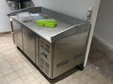 a kitchen with a stainless steel counter top and a sink