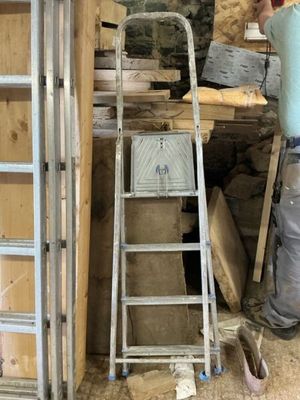 a man that is standing next to a ladder
