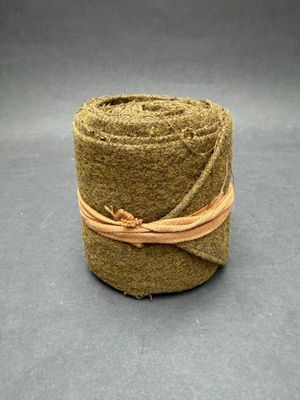 a close up of a roll of grass on a gray surface