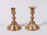 pair of brass candlesticks on a white background