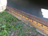 a close up view of a black and yellow bulldozer