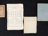 several old papers are on a black surface with a black background