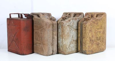 several old metal cans are lined up on a white surface
