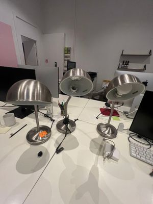 three lamps sitting on a white table in a room