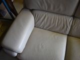 a white leather couch that is sitting in a room