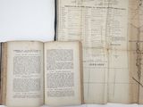 an open book with a map on it sitting on a table