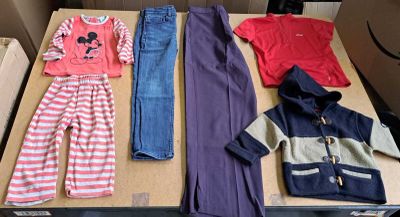 a lot of clothes that are sitting on a table