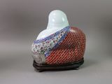 an image of a small vase with a bird on top of it
