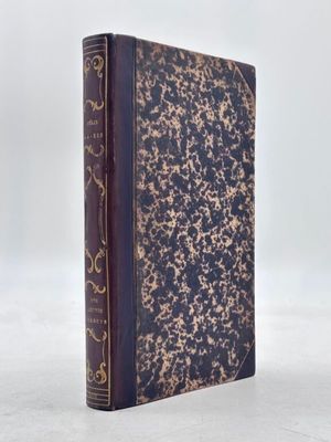 an old book sitting on top of a white surface