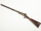 a rifle with a wooden barrel and a wooden handle