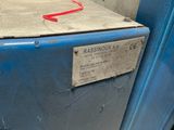 a blue refrigerator with a red handle and a tag on it