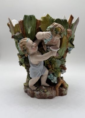 a figurine of a boy and a girl in a vase