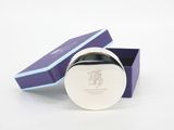purple and blue gift box with a silver lid and a logo on the lid