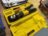 a yellow tool case with tools in it on a table