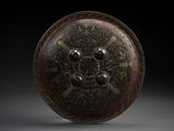 an image of a bronze plate with a circular design on it