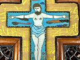 wooden cross with a painting of jesus on it on a wall