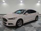 a white ford monde is parked in a room with a checkered floor