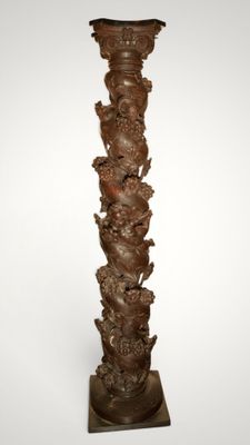an image of a tall vase with a bunch of animals on it