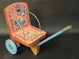 a small wooden toy with a blue handle and a spool