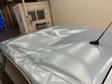 a car with a antenna on top of it in a garage