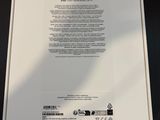the back of a white box with a green sticker on it