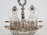 a silver plate with two glass bottles and a silver tray
