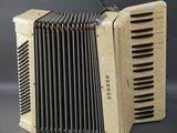 an old accordion sitting on top of a gray surface