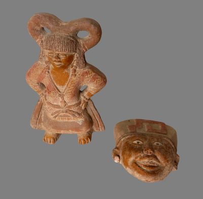 two clay figurines of a woman and a man on a gray background