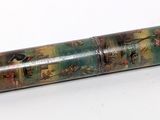a small metal tube with a painting on it