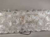 a close up of a light fixture made of glass