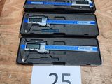 three calipers are sitting on a table with a number 25 on it