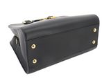 a black leather handbag with gold hardware on the handle