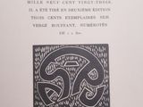 an open book with a black and white drawing of a snake on it