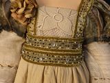 an image of a close up of a doll wearing a dress