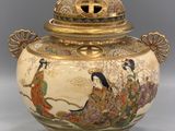 an image of a large vase with a lid and a design on it