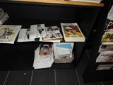 a lot of magazines on the shelf in the room