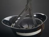 a black bowl with a pair of scissors in it