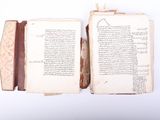 an open book with arabic writing on it sitting on top of a white surface