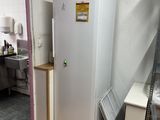 a refrigerator that is sitting in a room next to a window