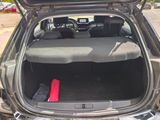 a trunk of a car with a red blanket in the trunk