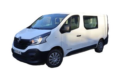 the white van is parked on the side of the road