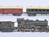 three toy trains sitting side by side on a white surface