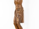 statue of a man hanging from a rope on a white wall