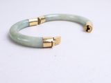 a close up of a bracelet on a white surface