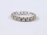 a close up of a diamond ring on a white surface