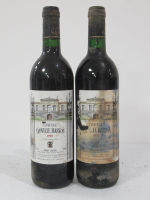 two bottles of wine sitting next to each other on a table