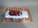 a white car with a red seat in a plastic box