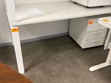 a white desk with a computer on it in a room