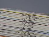 a lot of books that are stacked on top of each other